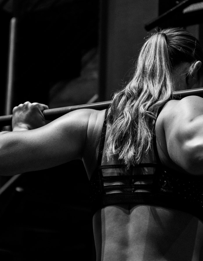 Woman doing a barbell back squat